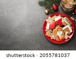 Tasty gingerbread cookies and space for text on grey table, flat lay. St. Nicholas Day celebration