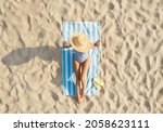 Woman Sunbathing On Beach Towel ...