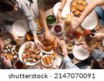 Small photo of Group of people having brunch together at table, top view