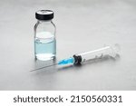 Small photo of Syringe and vial on grey table. Medical anesthesia