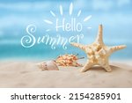 Hello Summer. Beautiful starfish and seashells on sandy beach