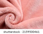 Soft pink fabric as background, top view