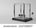 Small photo of Newton's cradle on light background, space for text. Physics law of energy conservation