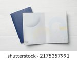 Blank passports on white wooden table, flat lay