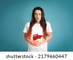 Small photo of Sick woman suffering from pain and illustration of unhealthy liver on light blue background. Viral hepatitis