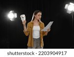 Small photo of Professional actress reading her script during rehearsal in theatre