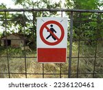 Sign Access forbidden all unauthorized persons with text in Italian attached to fence