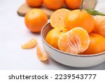 Fresh juicy tangerines on light grey table, closeup. Space for text