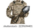 Small photo of Soldier in Ukrainian military uniform with folding sapper shovel on white background, closeup