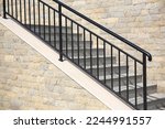 View of beautiful stairs with metal handrail near brick wall outdoors