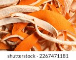 Many dry orange peels on white table, closeup