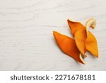 Dry orange peels on wooden table, top view. Space for text