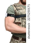 Small photo of Soldier in military uniform applying medical tourniquet on arm against white background, closeup