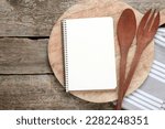 Blank recipe book and kitchen utensils on old wooden table, flat lay. Space for text