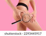 Small photo of Cellulite problem. Slim woman in underwear on pink background, closeup. Zoomed skin with orange peel syndrome, view through magnifying glass