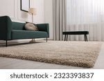 Stylish living room with soft beige carpet and sofa. Interior design