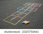 Small photo of Hopscotch drawn with colorful chalk on asphalt outdoors, closeup