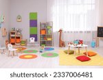 Small photo of Child`s playroom with different toys and furniture. Cozy kindergarten interior