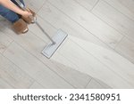 Small photo of Woman washing floor with mop indoors, top view. Clean trace on dirty surface