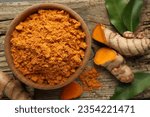Small photo of Aromatic turmeric powder and raw roots on wooden table, flat lay