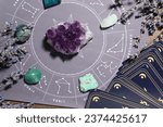 Small photo of Astrology prediction. Zodiac wheel, gemstones, tarot cards and lavender on wooden table, flat lay