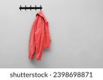 Coral jacket hanging on coat...