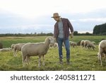 Man in hat with sheep on...