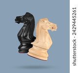 Small photo of Wooden chess knights in air on greyish blue background