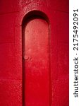Small photo of Narrow red door in the context of mystery and the uncanny.
