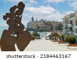 Small photo of Sitges, Spain; 30 07 2022: Sculpture by Horacio Elena, titled woman looking at the sea of the year 2007 made in iron in the square where the Hermitage of Sant Sebastian is located in Sitges Catalunya