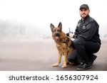 Male Police Officer With Dog...