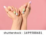 Hands of young woman with beautiful manicure on color background