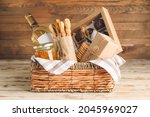 Gift basket with products on wooden background