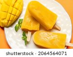 Composition with mango ice cream on color background