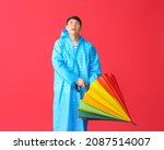 Young Asian Man In Raincoat And ...
