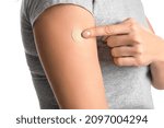 Small photo of Mature woman with applied nicotine patch on white background, closeup. Smoking cessation