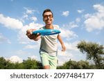 Small photo of Young man playing frisbee in park