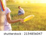 Funny little children playing frisbee outdoors on sunny day