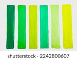 Green and yellow paints on white background
