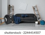 Interior of messy living room with shelf units and sofa near light wall
