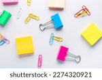 Binder clips and sticky notes on grey background