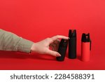 Woman with pepper sprays on red background
