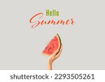 Hand with piece of ripe watermelon and text HELLO, SUMMER on grey background