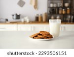 Plate with cookies and glass of ...