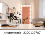 Small photo of Different hairdressing tools on table in beauty salon
