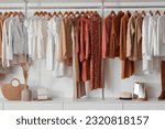 Stylish female clothes hanging in boutique