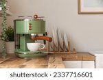 Modern coffee machine with cup on wooden kitchen counter, closeup