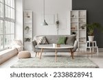 Small photo of Interior of light living room with grey sofa, coffee table and big window