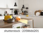 Small photo of Blender, toaster, juicer, oranges and cooking pot on wooden table in kitchen