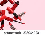 Red lipsticks flying on pink background